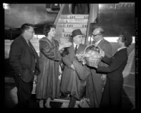 Actress Sophia Loren and husband Carlo Ponti being greeted by Marcello Girosi upon arriving in Los Angeles, Calif., 1958