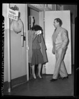 Coy August, in women's clothing with police officer in Los Angeles, Calif., 1946