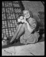 Pat Graham poses with oranges at the National Orange Show, San Bernardino, 1933