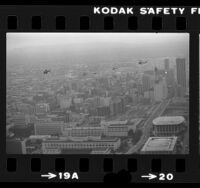 Five helicopters flying over Los Angeles Civic Center in tribute to failed hostage rescue mission in Iran, 1980