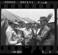 Former South Vietnamese Premier Nguyen Cao Ky talking with other refugees at Camp Pendleton, Calif., 1975