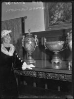 Hersee Moody Carson standing next to a three-piece set of royal blue Sèvres porcelain, Los Angeles, 1935