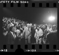 Boxer Muhammad Ali making way through crowd during retirement salute at the Forum in Inglewood, Calif., 1979