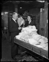 Postmaster Henry B. R. Briggs and Peggy Milligan in a postal facility, Los Angeles, 1934-1936