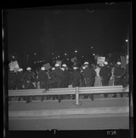 Police push protesters back near Century Plaza at demonstration during President Lyndon Johnson's visit, 1967