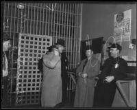 Otis Porter evades reporters after his arrest for robbery, Los Angeles, 1935