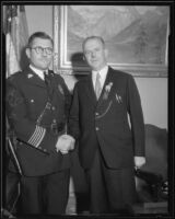 Roy E. Steckel, Chief of Police, shakes hands with an official from the National Committee, Los Angeles, 1929-1933