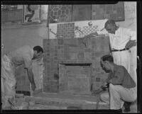 Men laying tiles on a fireplace, Los Angeles, 1935
