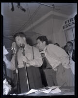 William Elconin, of CIO electrical workers union and Jeff Kibre on stage during aircraft workers' rally, 1941