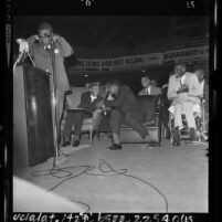 Black Muslim rally with Elijah Muhammad shaking hands with Cassius Clay in Los Angeles, Calif., 1964