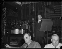 Herbert Hoover speaking in front of flag, Los Angeles, 1930s