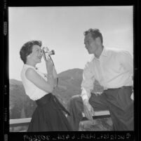 Charlton Heston poses for his wife at their home in Beverly Hills, Calif., 1960