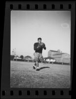 Bud Langley, USC football player, about to kick a football, Los Angeles, 1935