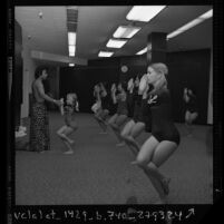 Bikram Choudhary conducting Hatha yoga class, pretzel pose, in Los Angeles, Calif., 1974