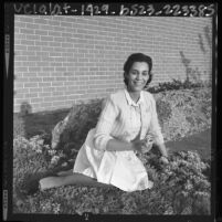 Los Angeles County Deputy Sheriff and homemaker Patricia Wood seated in her garden, 1964