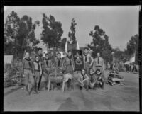 Boy Scouts posing with a framed "Be Prepared" emblem at an event in a park, circa 1935