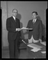 Carl S. Kegley, attorney, receives a document from Municipal Judge Wilbur C. Curtis, Los Angeles, circa 1933