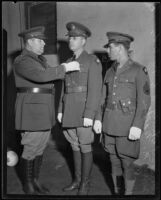 Colonel Harcourt Hervey pinning decorations on the uniforms of other military officers, Los Angeles