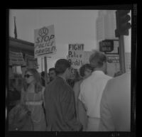 Protester Janet King at the Hall of Justice in downtown Los Angeles talks to pickets after being arraigned on felony charges stemming from the demonstration at Century Plaza during President Johnson's visit. A. 1967