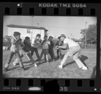 Former boxer Mando Ramos working with boys at Mahar House in Wilmington, Calif., 1988