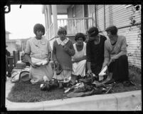 Women providing clothing to survivors of the fire that destroyed the Hope Development School for mentally disabled girls in Playa del Rey, Los Angeles, 1924