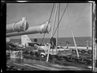 Two sailors walk the deck of a US Navy battleship