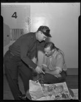 O.J. Johnson assists Herbert J. Teater, weak from hunger, Los Angeles, 1935