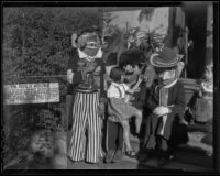 Two little girls and three Mascaras, Olvera Street, Los Angeles, 1936