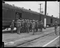 California National Guard members next to train on Exposition Boulevard, Los Angeles, circa 1928-1939