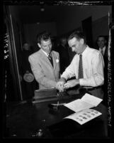 Frank Sinatra being fingerprinted by police officer Robert Rogers for gun permit in Los Angeles, Calif., 1947