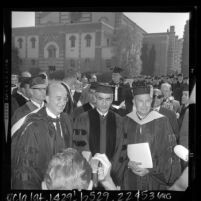 Shah of Iran, Mohammed Reza Pahlavi flanked by Dr. Clark Kerr and Franklin D. Murphy on UCLA campus after receiving honorary degree, Los Angeles, 1964