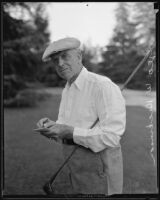 George W. Dickinson holding golf club at the Los Angeles Country Club, Los Angeles, 1935