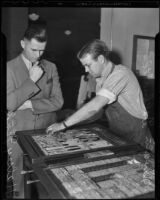 Mayor Halsey Fink watches Dwain Galbraith prepare an issue of the Los Angeles Times, Los Angeles, 1936