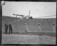 Occidental high jumper knocks over the bar on his jump attempt during the U.S.C. and Occidental dual track meet, Los Angeles, [1926]