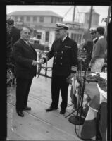 Mayor Frank Shaw and Admiral Thomas Senn shake hands an an official event, Los Angeles, circa 1933