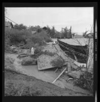 Flood damage in a residential neighborhood after a rain storm, Los Angeles County, 1969