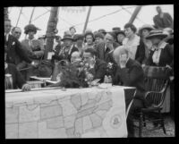 Men listen in to a phone call from President Warren G. Harding to his sister, marking the opening of the Valencia Orange Show, Anaheim, 1921