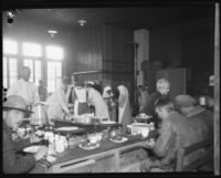 Flood relief workers (?) eating at a u-shaped bar following the failure of the Saint Francis Dam, Santa Clara River Valley (Calif.), 1928