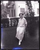 Katharine Shepler Bledsoe sitting on a chair outdoors, Los Angeles, circa 1920s