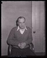 Police detective Edward "Eddie" P. Nolan sitting in chair, charged with murder, Los Angeles, circa 1931