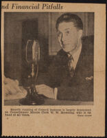 Warren W. Browning, city council minute clerk, seated with papers behind a microphone, Los Angeles, 1935