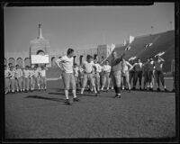 Coach Howard Jones instructing his team at the Coliseum. Los Angeles, 1925-1939