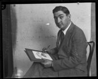 Portrait of caricaturist Henry Major as he draws one of his famous cartoons, Los Angeles, 1925