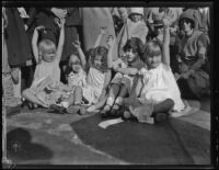 Five girls with curb-front seats for Rose Parade, Pasadena, 1930