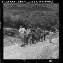 Group of blind boys being led up hill on hike at Camp Bloomfield in the Malibu Mountains, Calif., 1964