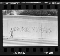 Graffiti stating "No Boring Murals" covering sketch for mural on underpass in Santa Monica, Calif., 1981