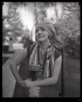 Millicent Sunday seated in a chair in a park or yard, Los Angeles, 1928