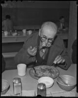 Donald W. McLean eats a Christmas dinner at the Midnight Mission, 1935