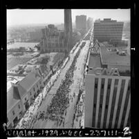 Birds-eye view of demonstrators walking down Wilshire Blvd. in peace parade, Los Angeles, Calif., 1967