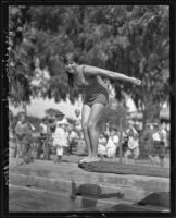 Swimming mermaid Marion Himmelstein preparing to dive, Los Angeles, 1925